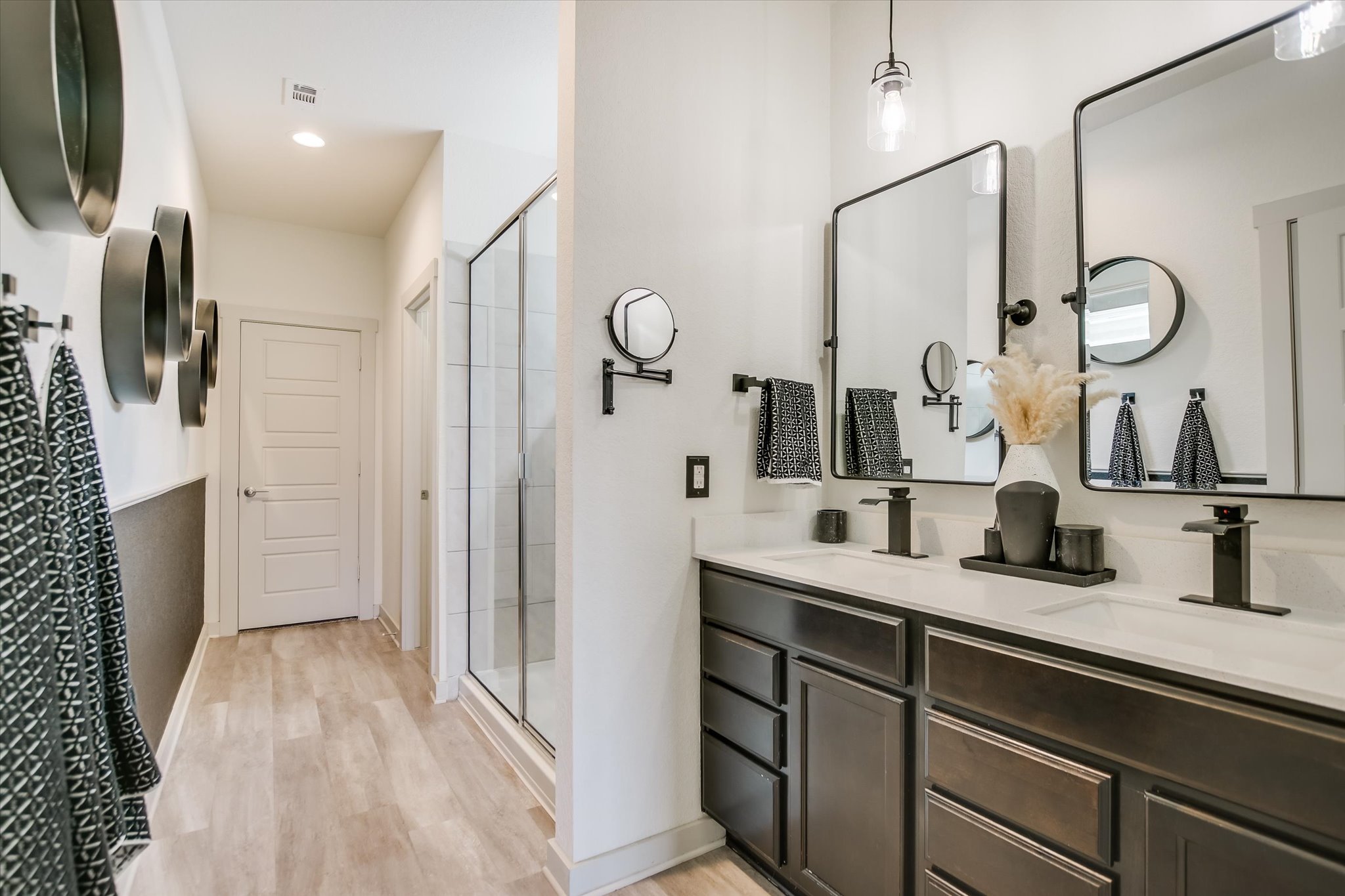 117 Deserti Road Leander, TX 78641 - Photo 11 of 21 Bathroom featuring double vanity, light wood finished floors, and a stall shower