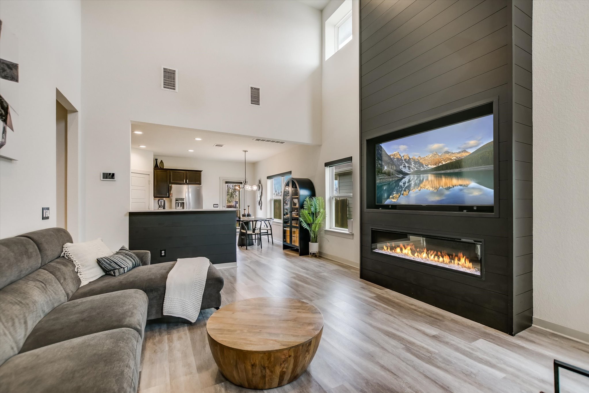117 Deserti Road Leander, TX 78641 - Photo 4 of 21 Living area with plenty of natural light, light wood finished floors, a large fireplace, and a high ceiling