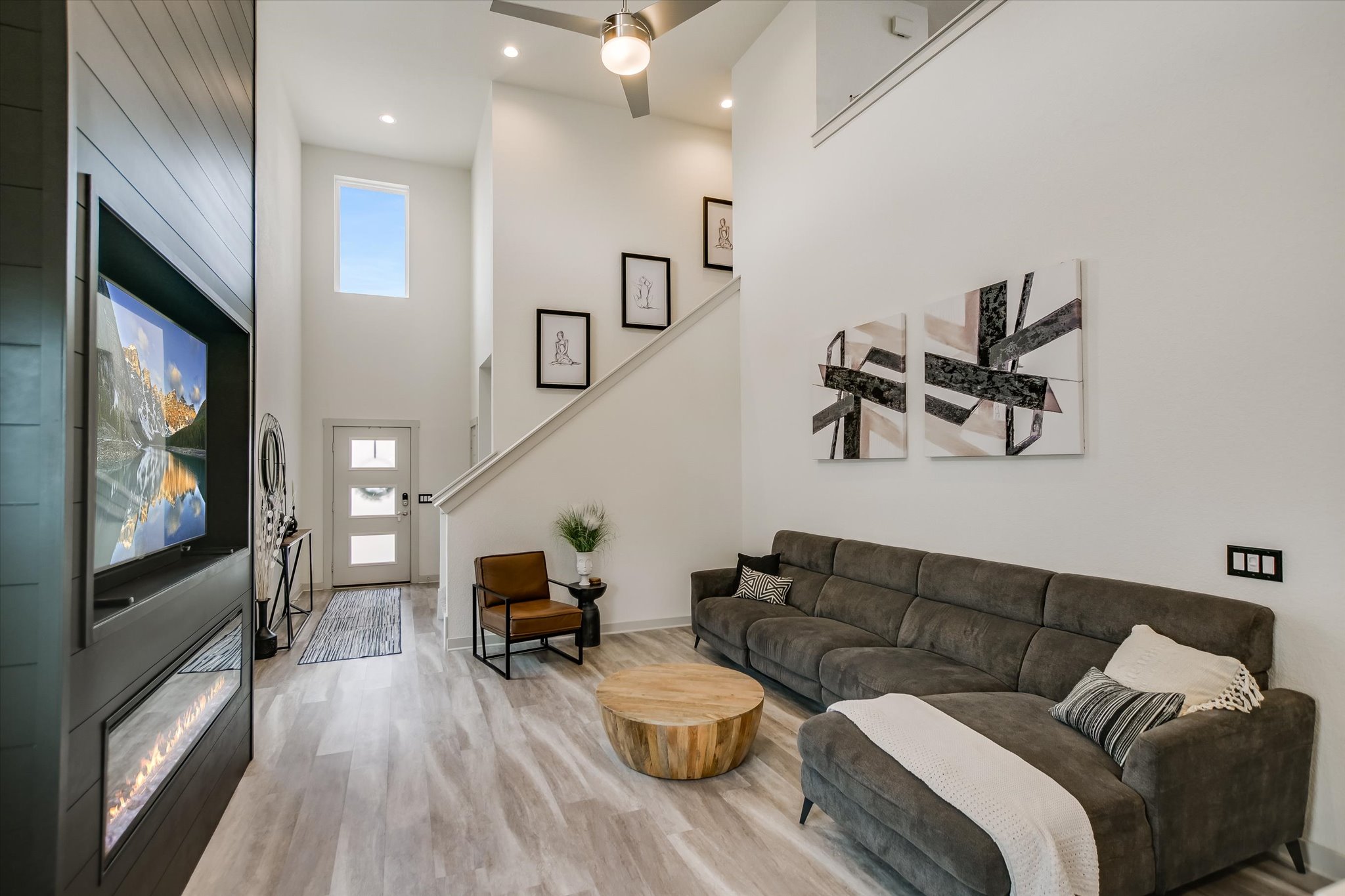 117 Deserti Road Leander, TX 78641 - Photo 5 of 21 Living room with a high ceiling, light wood finished floors, a fireplace, and recessed lighting