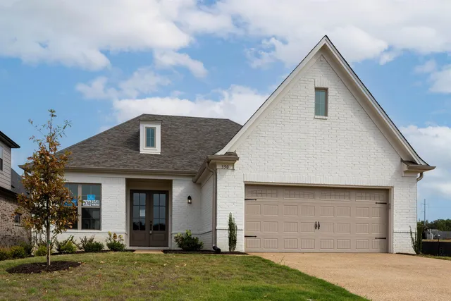 a view of a house with a yard and plants