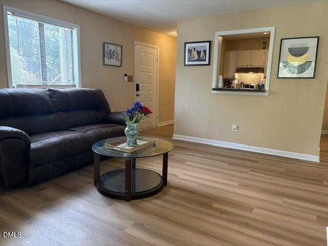 5816 Pointer Drive, Unit 102 Raleigh, NC 27609 - Photo 3 of 25 a living room with furniture and a window