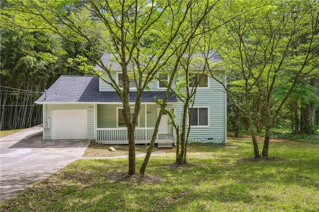 a view of backyard of house with green space