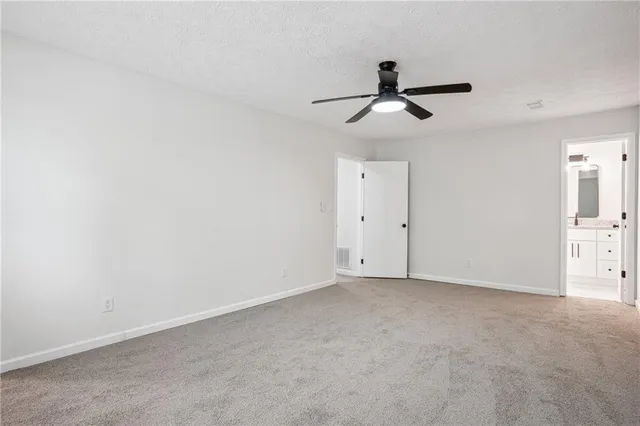 an empty room with closet and windows