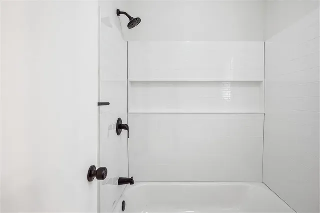 a bathroom with a granite countertop sink a toilet and a mirror