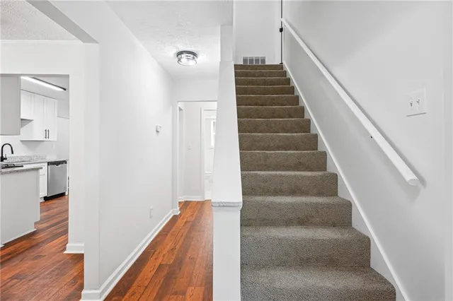 a view of entryway and hall with wooden floor