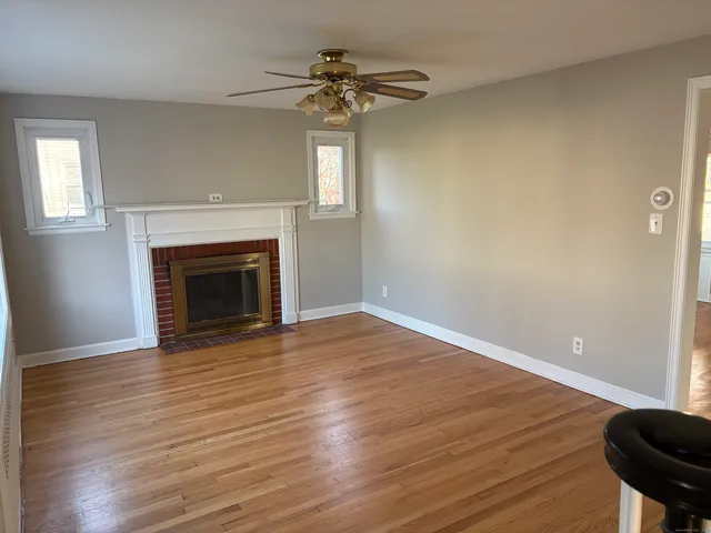 wooden floor in an empty room with a fireplace