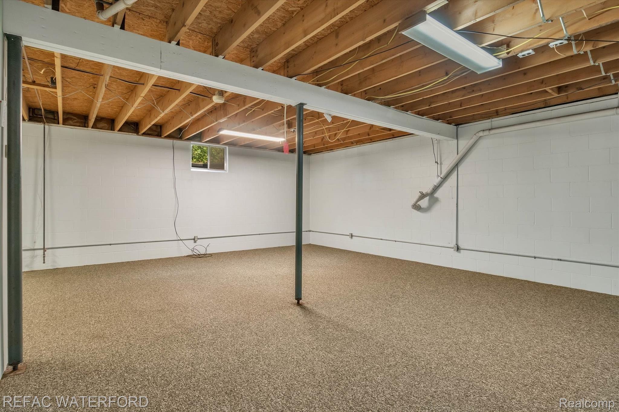 480 Roscommon Road Roscommon, MI 48653 - Photo 29 of 65 Basement view from behind stairwell. Carpeted for entertaining.