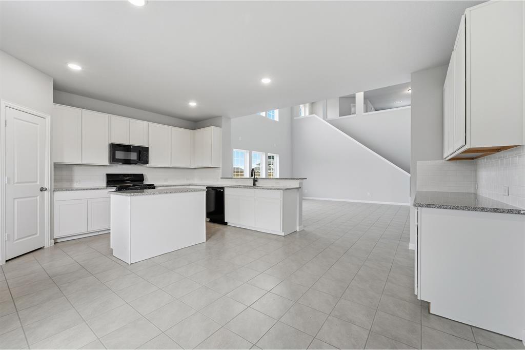 343 Caviar Road Waxahachie, TX 75165 - Photo 11 of 22 a kitchen with white cabinets and white appliances
