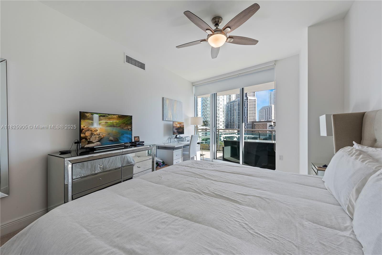 350 South Miami Avenue, Unit 1102 Miami, FL 33130 - Photo 11 of 29 a bedroom with a bed and a flat screen tv