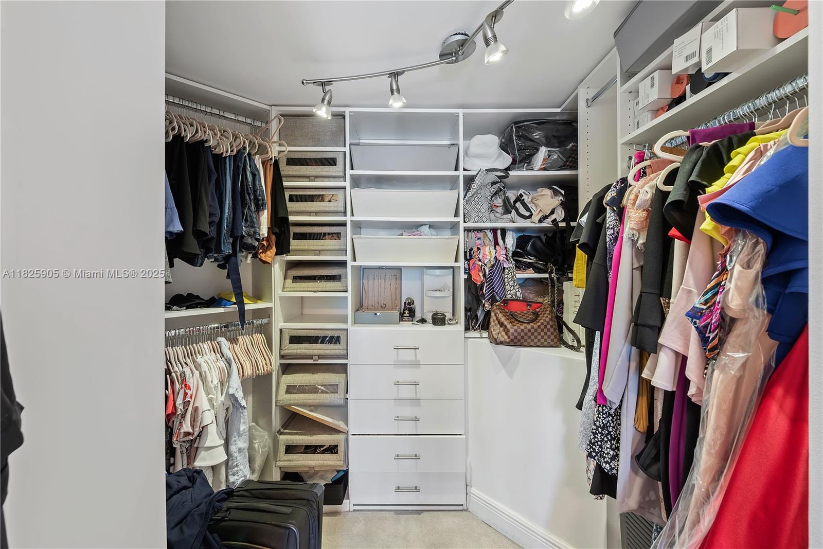 350 South Miami Avenue, Unit 1102 Miami, FL 33130 - Photo 15 of 29 a view of walk in closet with clothes and shoes