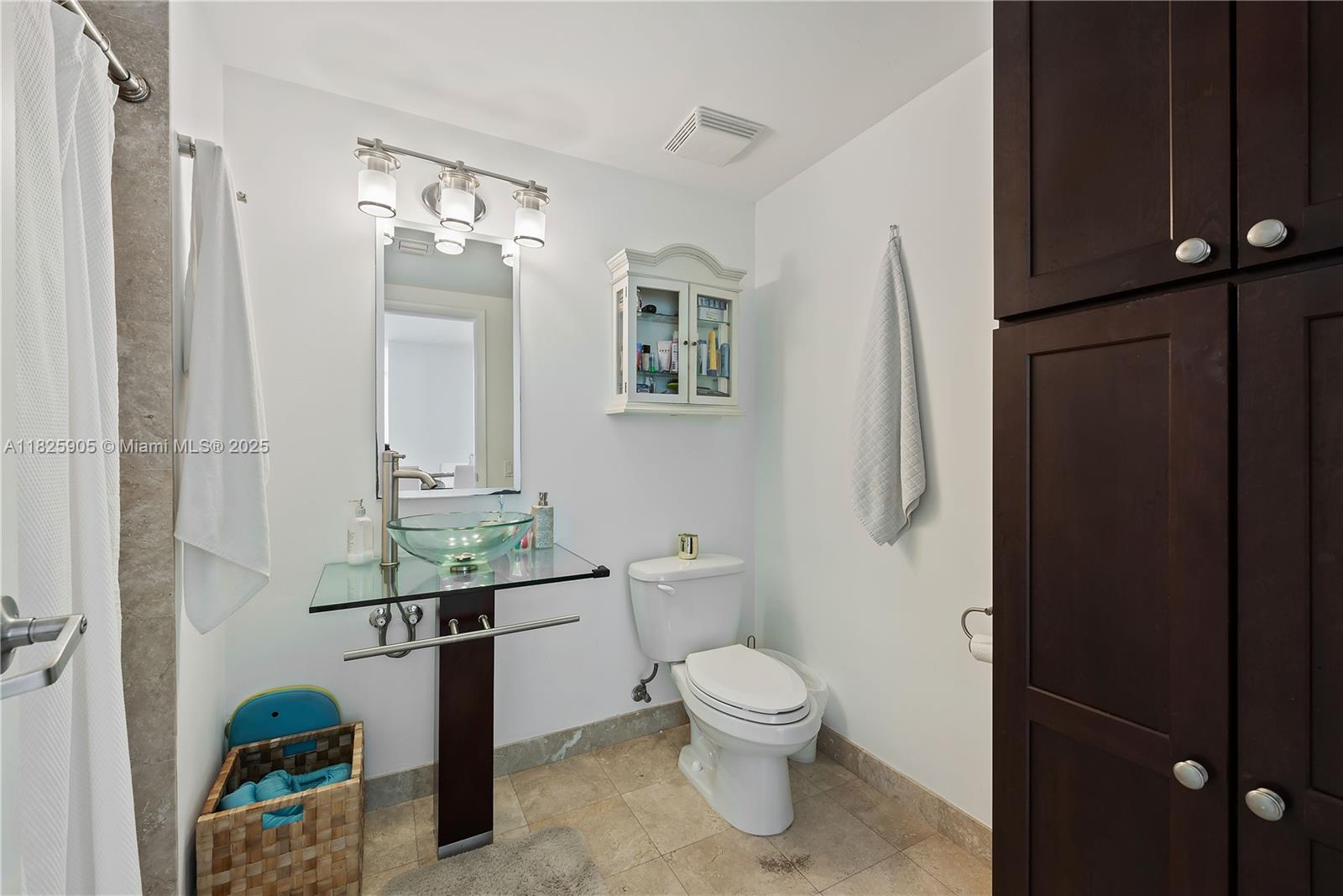 350 South Miami Avenue, Unit 1102 Miami, FL 33130 - Photo 17 of 29 a bathroom with a toilet a sink and mirror