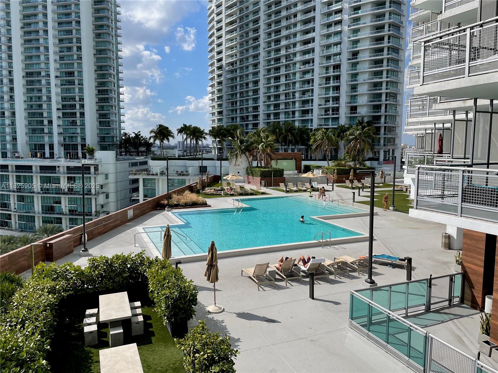 350 South Miami Avenue, Unit 1102 Miami, FL 33130 - Photo 20 of 29 a view of swimming pool with outdoor seating and plants