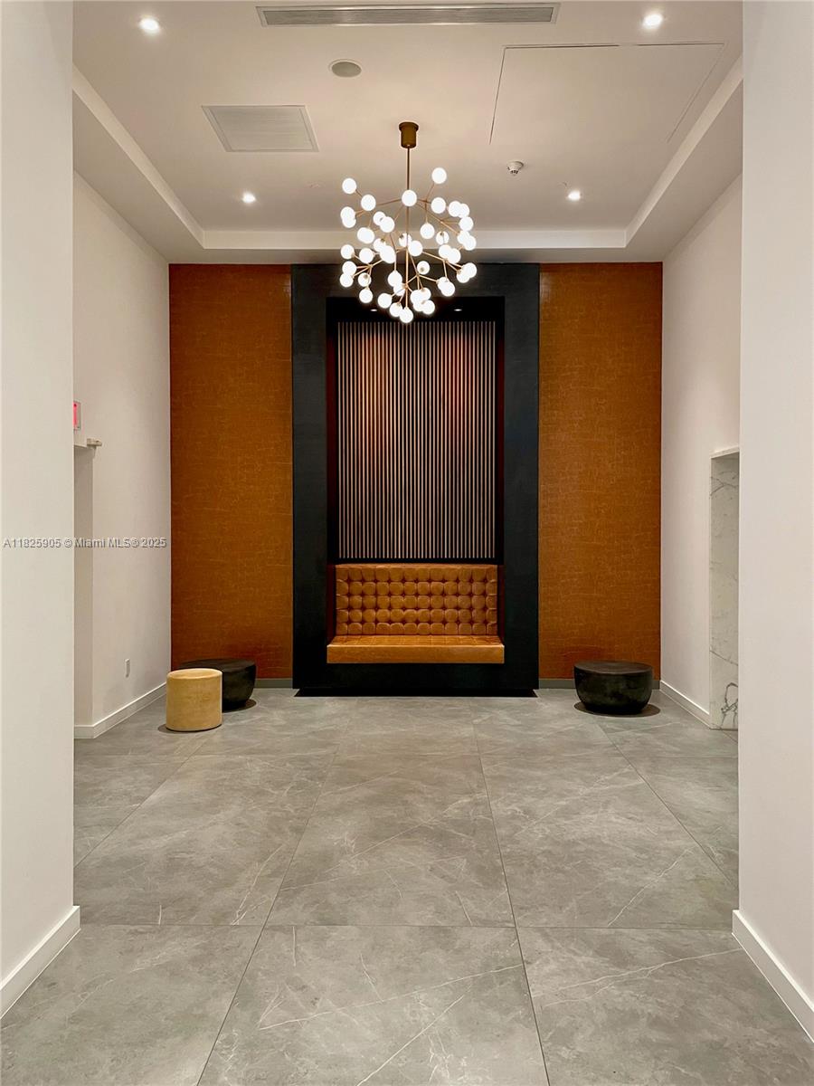 350 South Miami Avenue, Unit 1102 Miami, FL 33130 - Photo 27 of 29 a view of an empty room with a chandelier