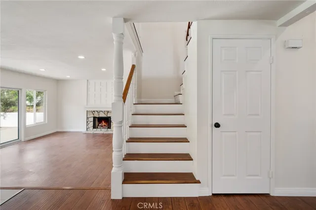 a view of entryway with wooden floor and stairs