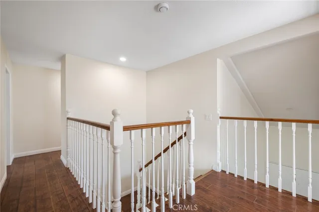 a view of a hallway with wooden floor and entryway