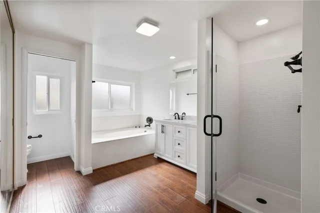 a bathroom with a tub shower and sink