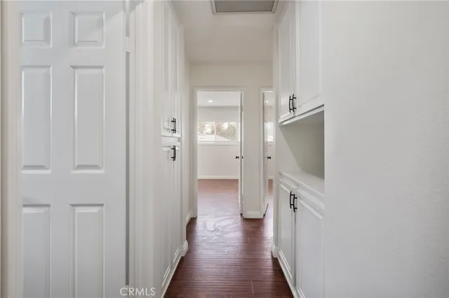 a view of a hallway with wooden floor