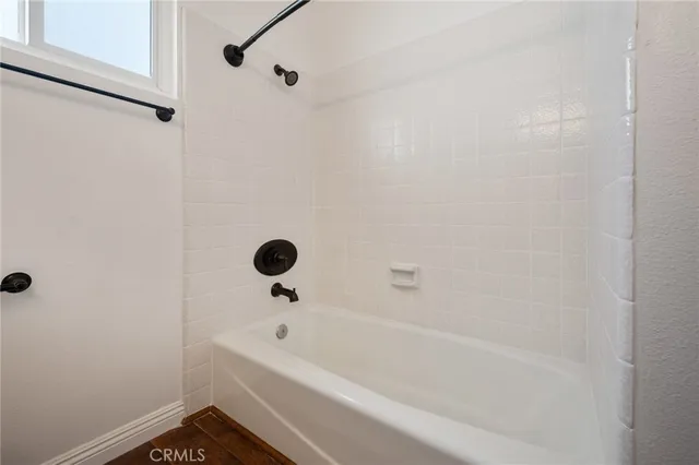 a bathroom with a bathtub and shower