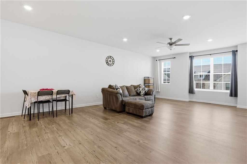 3535 Senna Road Duluth, GA 30096 - Photo 29 of 60 a living room with furniture and a wooden floor