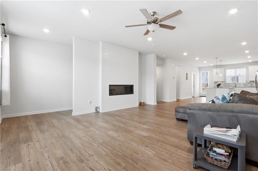 3535 Senna Road Duluth, GA 30096 - Photo 35 of 60 a living room with furniture and a wooden floor