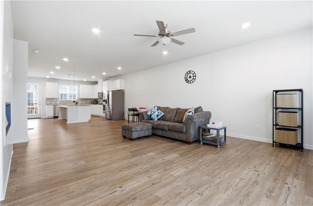 3535 Senna Road Duluth, GA 30096 - Photo 39 of 60 a living room with furniture and a wooden floor