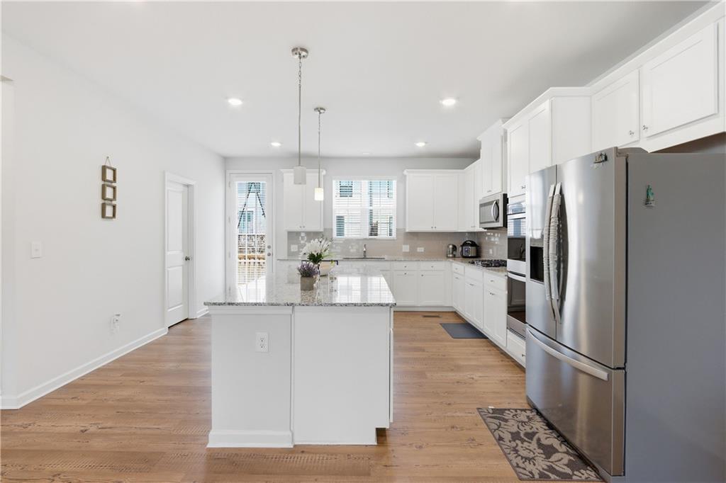 3535 Senna Road Duluth, GA 30096 - Photo 41 of 60 a large kitchen with stainless steel appliances kitchen island a stove a refrigerator a sink and a oven