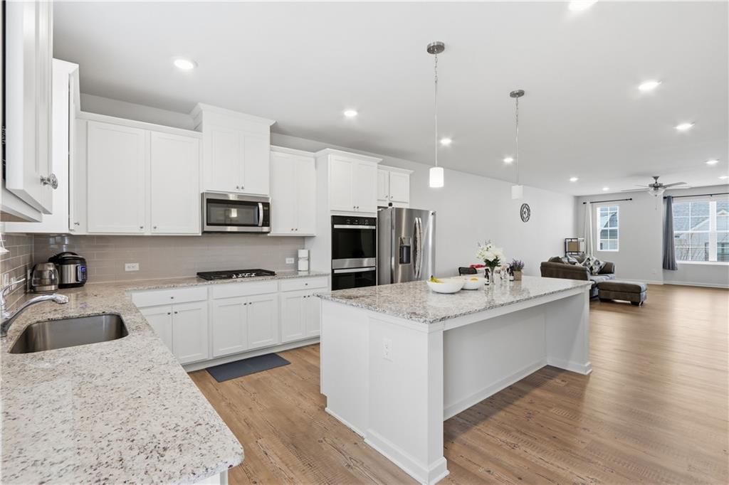 3535 Senna Road Duluth, GA 30096 - Photo 43 of 60 a kitchen with a sink stainless steel appliances and white cabinets