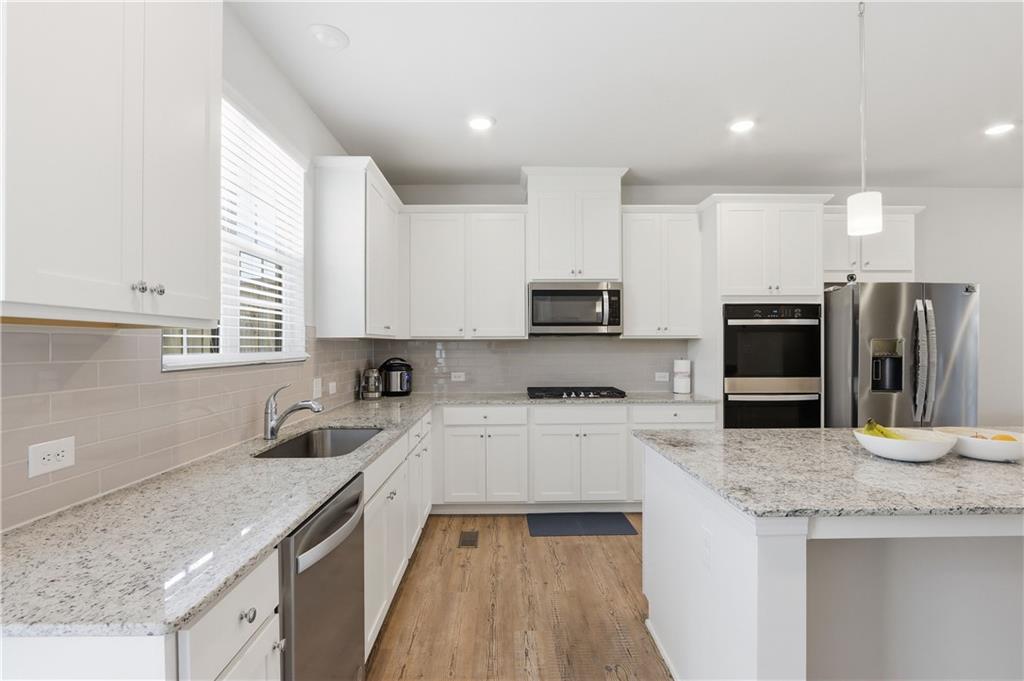 3535 Senna Road Duluth, GA 30096 - Photo 44 of 60 a kitchen with stainless steel appliances granite countertop a sink and microwave