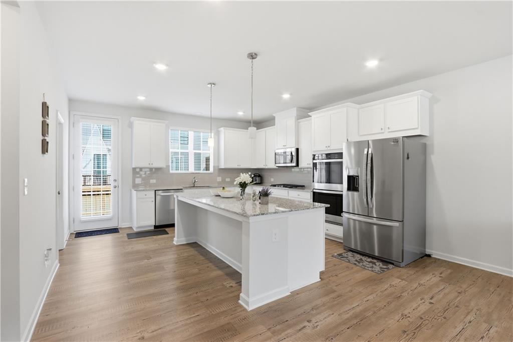 3535 Senna Road Duluth, GA 30096 - Photo 48 of 60 a large white kitchen with a stove top oven and refrigerator