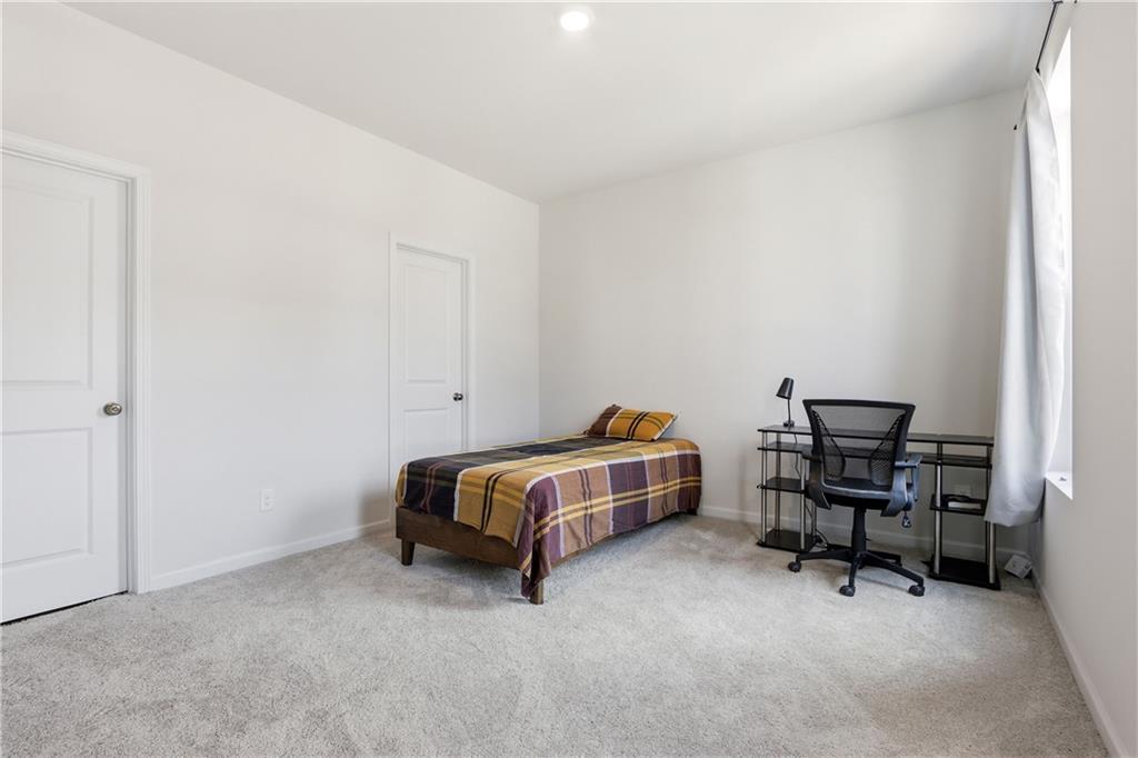 3535 Senna Road Duluth, GA 30096 - Photo 54 of 60 a bedroom with a bed and a chair