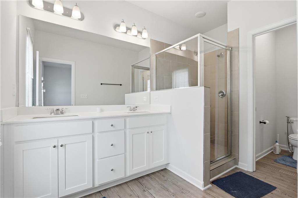 3535 Senna Road Duluth, GA 30096 - Photo 56 of 60 a bathroom with a double vanity sink and mirror