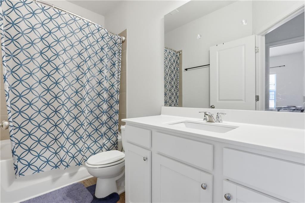 3535 Senna Road Duluth, GA 30096 - Photo 59 of 60 a bathroom with a sink a toilet and a mirror