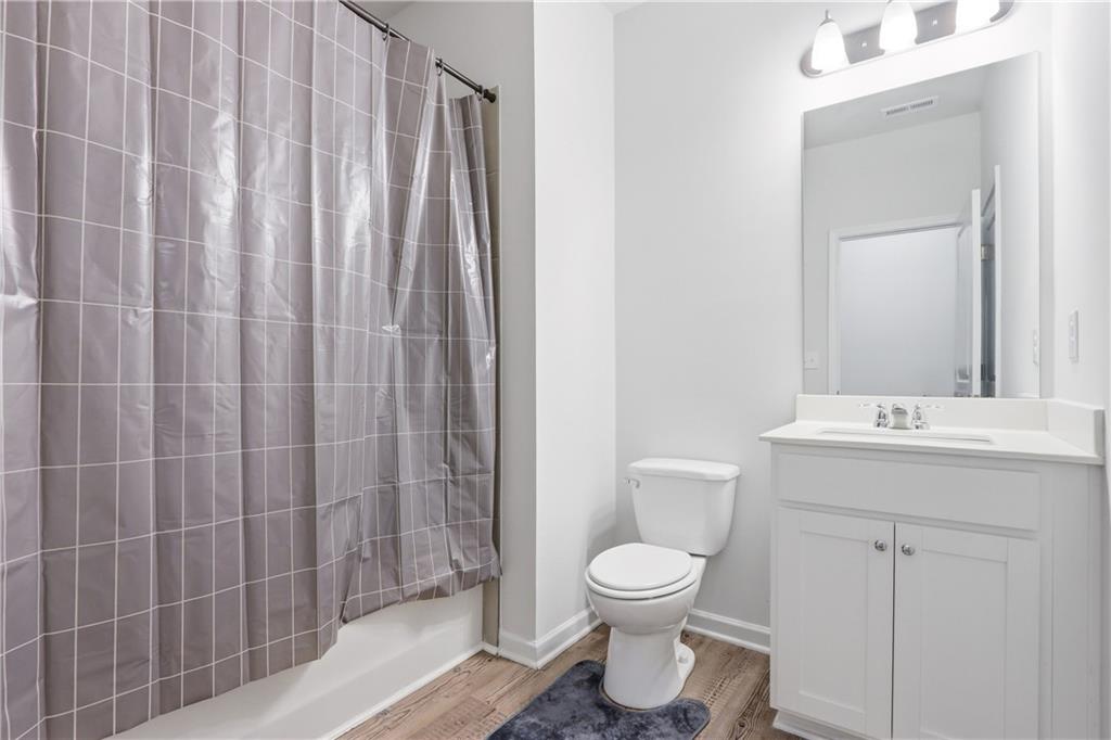 3535 Senna Road Duluth, GA 30096 - Photo 60 of 60 a bathroom with a toilet a sink and curtain
