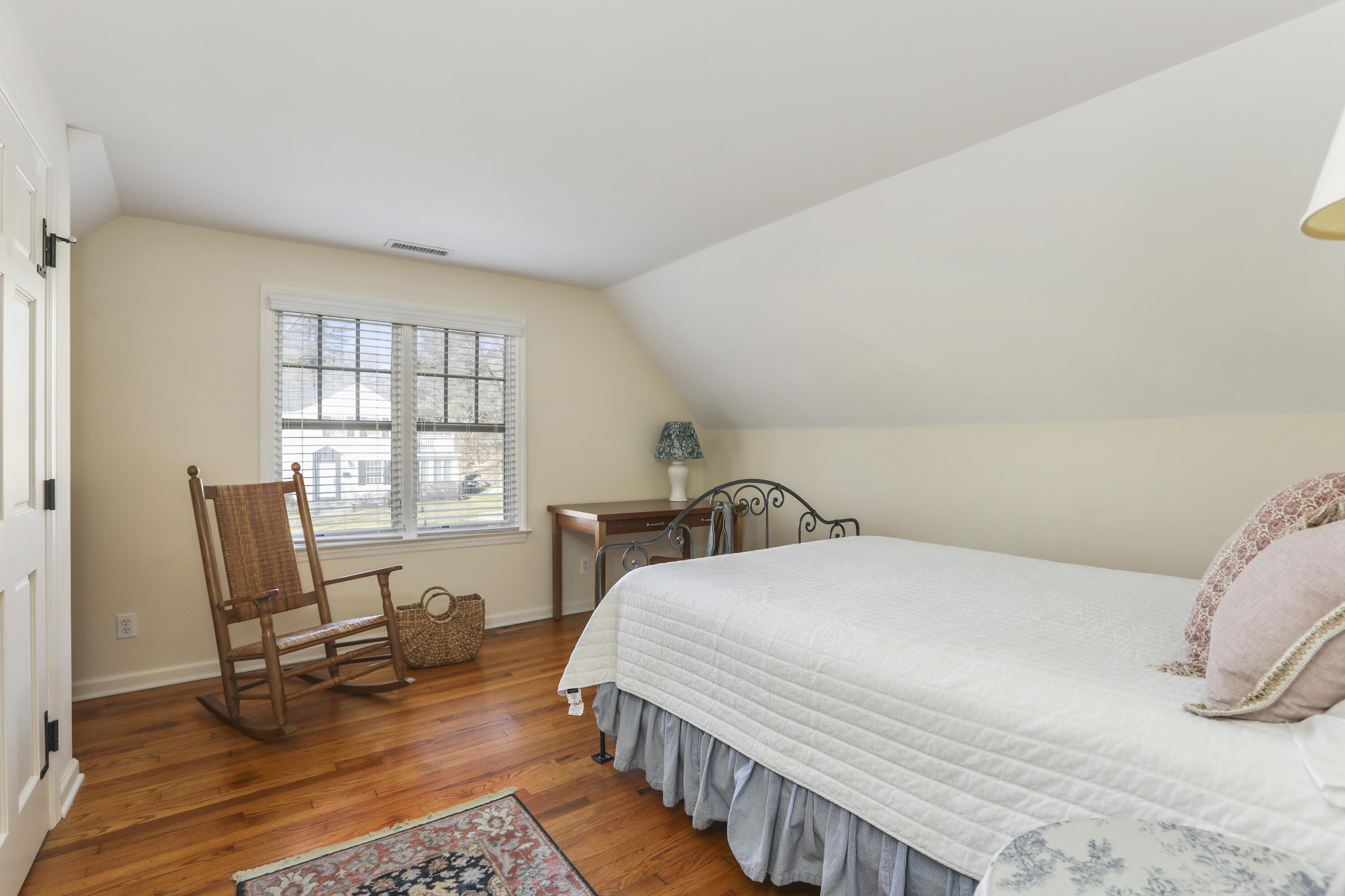 38 Intervale Road Darien, CT 06820 - Photo 20 of 30 a bedroom with a bed a chair and a large window