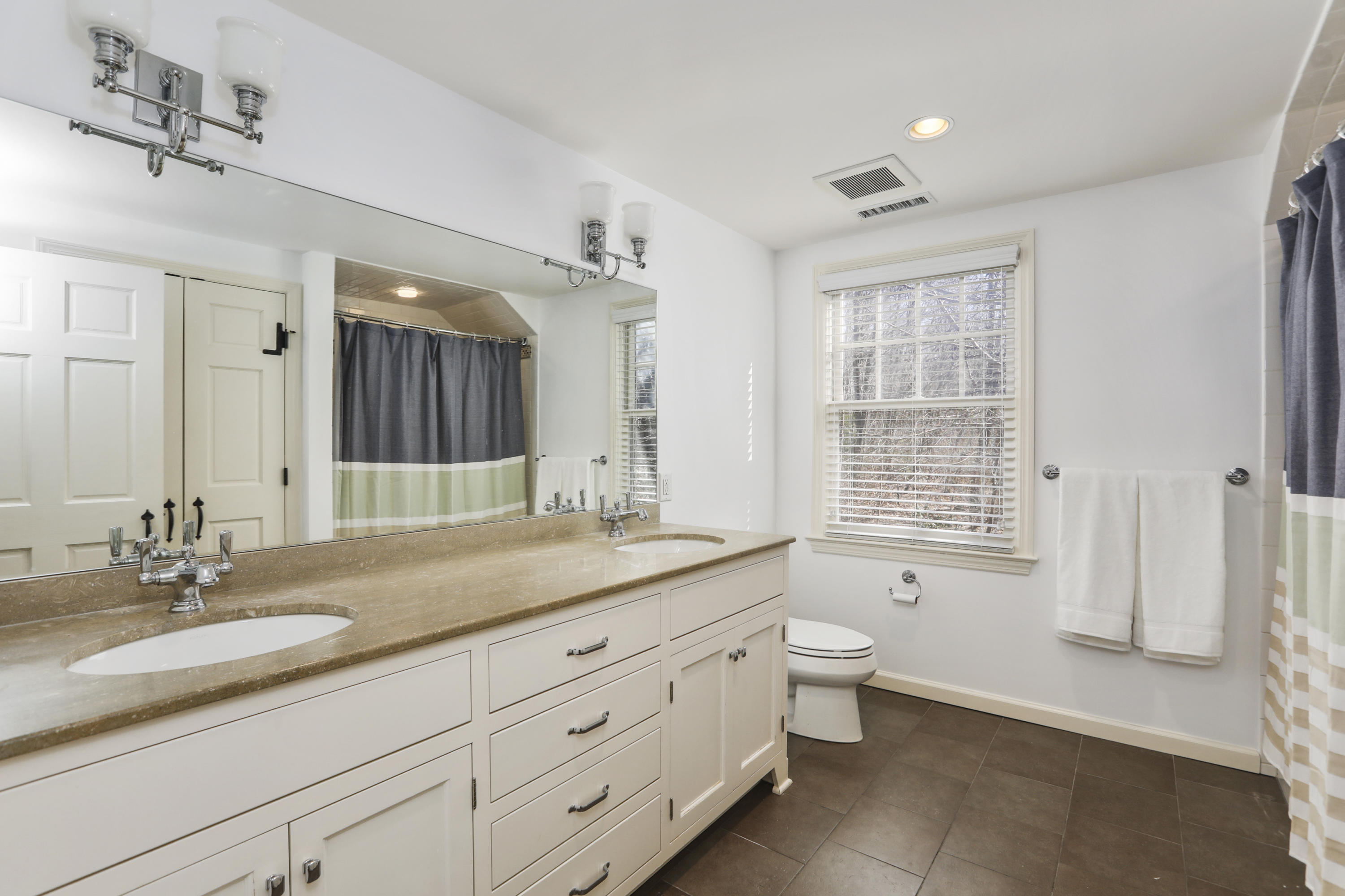 38 Intervale Road Darien, CT 06820 - Photo 21 of 30 a bathroom with a granite countertop double vanity sink a mirror and a bathtub