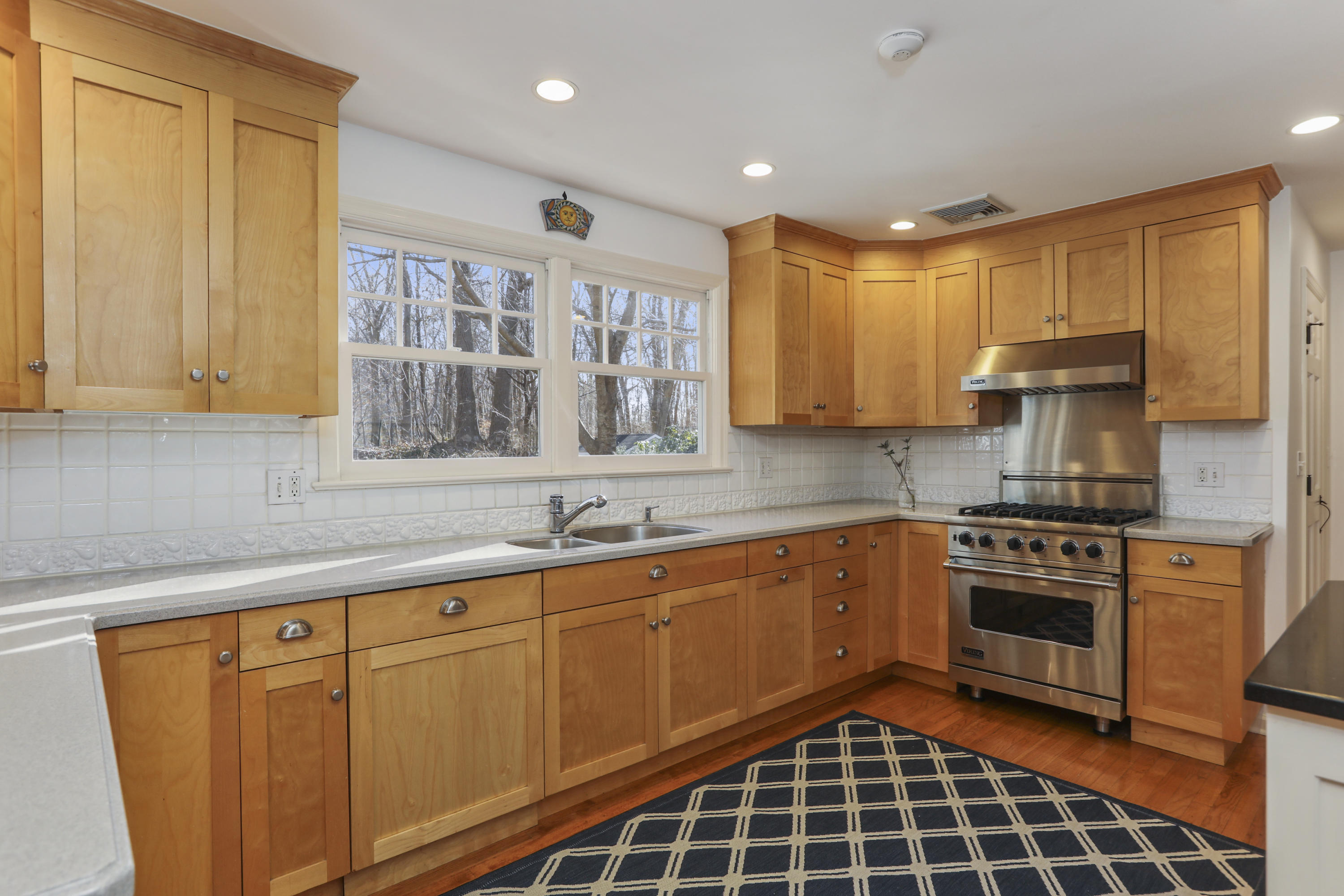 38 Intervale Road Darien, CT 06820 - Photo 9 of 30 a kitchen with stainless steel appliances a sink cabinets and a window