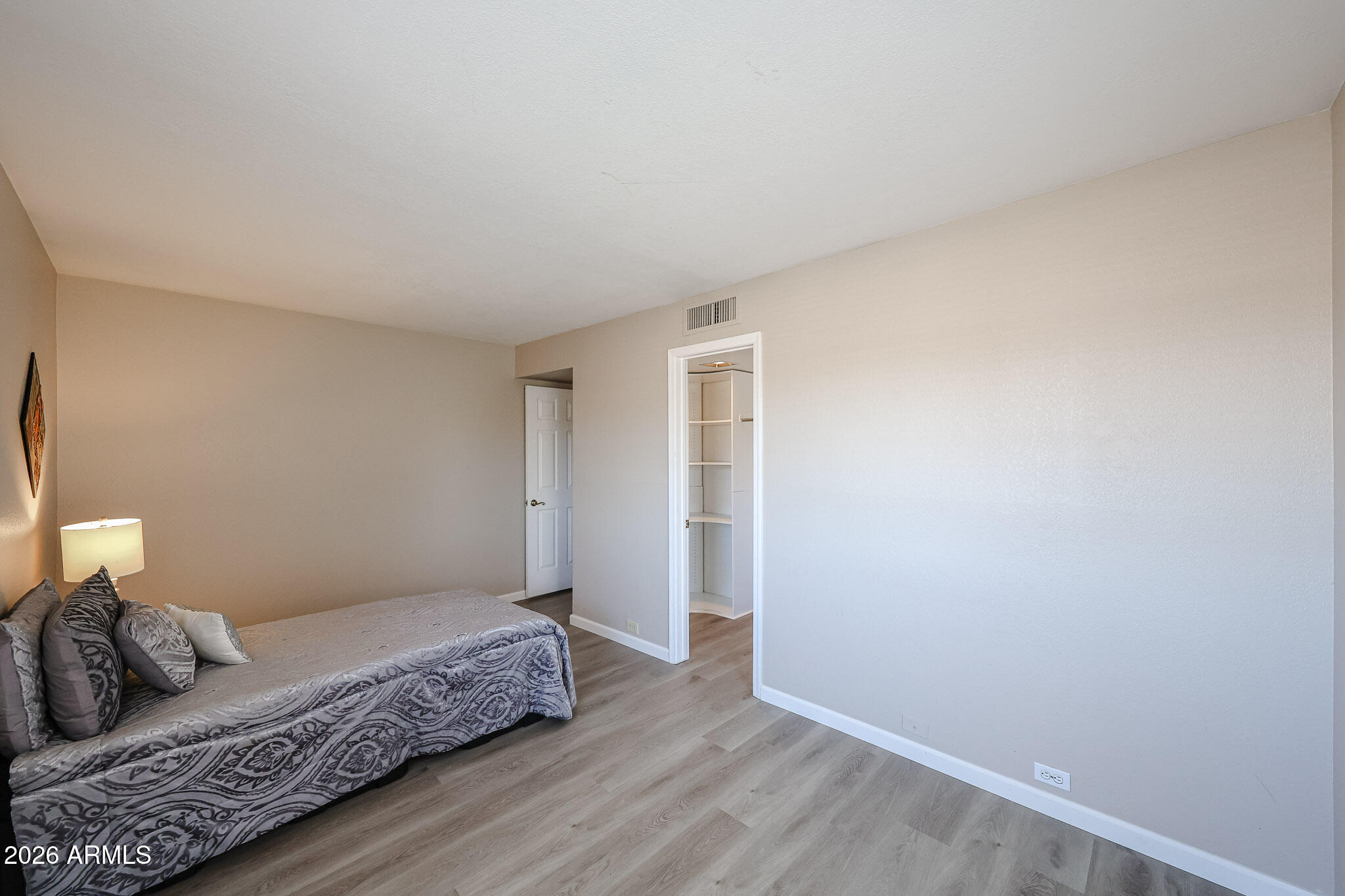 10410 North Cave Creek Road, Unit 1011 Phoenix, AZ 85020 - Photo 29 of 54 a bedroom with a bed and wooden floor