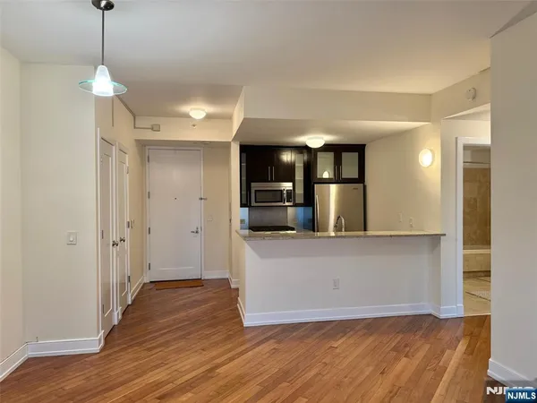 a view of a kitchen with a sink and a refrigerator