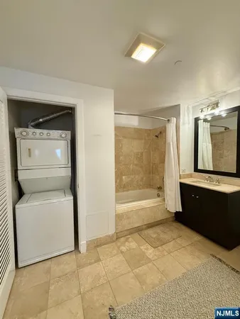 a bathroom with a bathtub sink and mirror