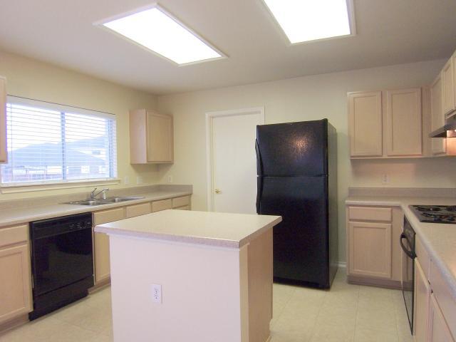7525 Springtime Trail Austin, TX 78747 - Photo 1 of 1 a kitchen with a sink and a refrigerator