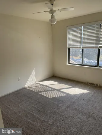 an empty room with a empty space and windows