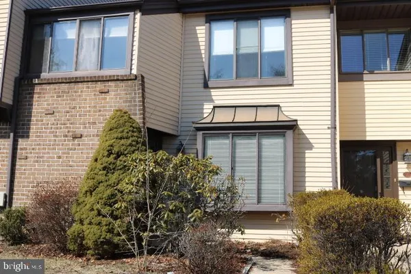 a brick house with a large windows