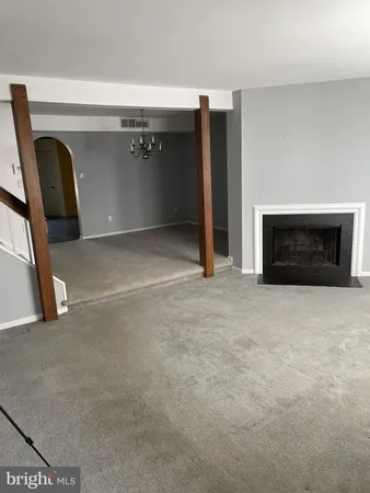 a view of empty room with a fireplace