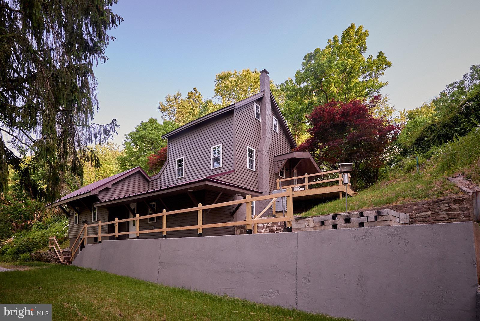 a view of a house with a yard and sitting area