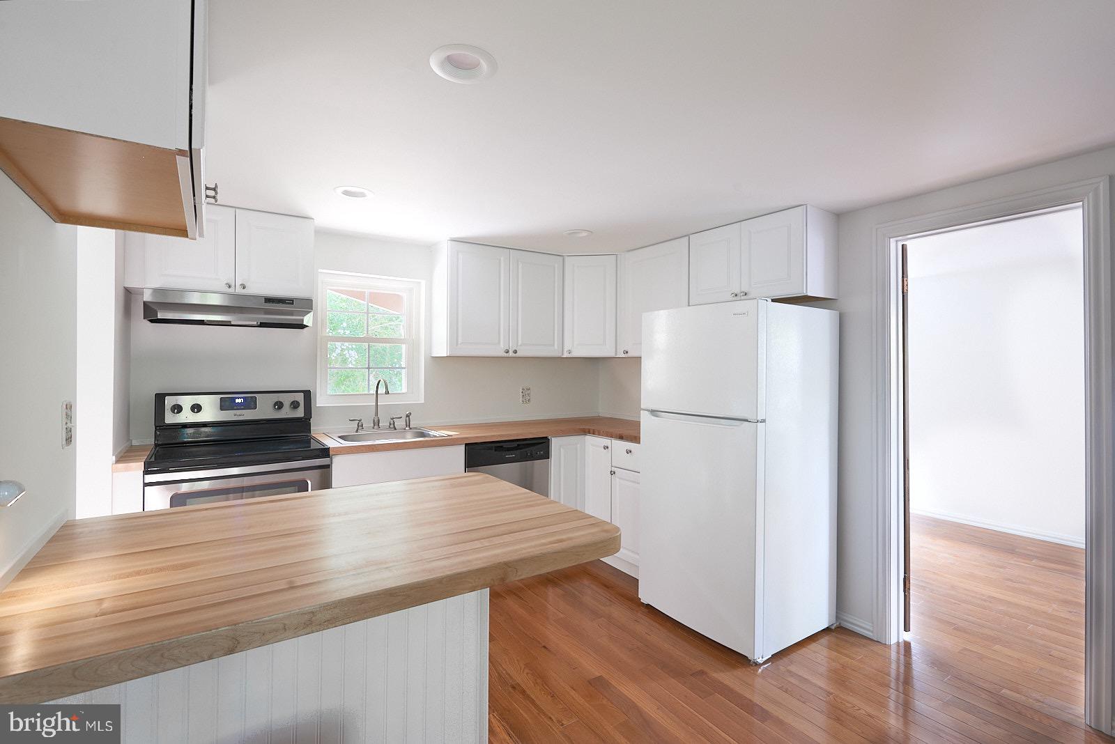 1321 Wyomissing Road Mohnton, PA 19540 - Photo 14 of 30 a kitchen with a refrigerator a stove a microwave and wooden floor