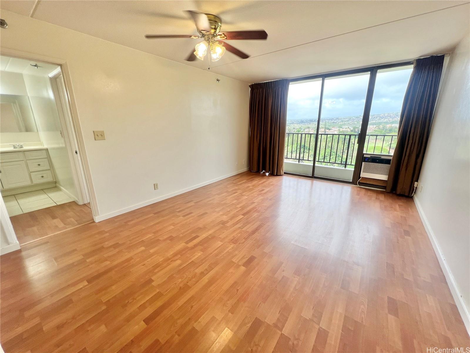 98-402 Koauka Loop, Unit 2113 Aiea, HI 96701 - Photo 1 of 7 wooden floor in an empty room with a window