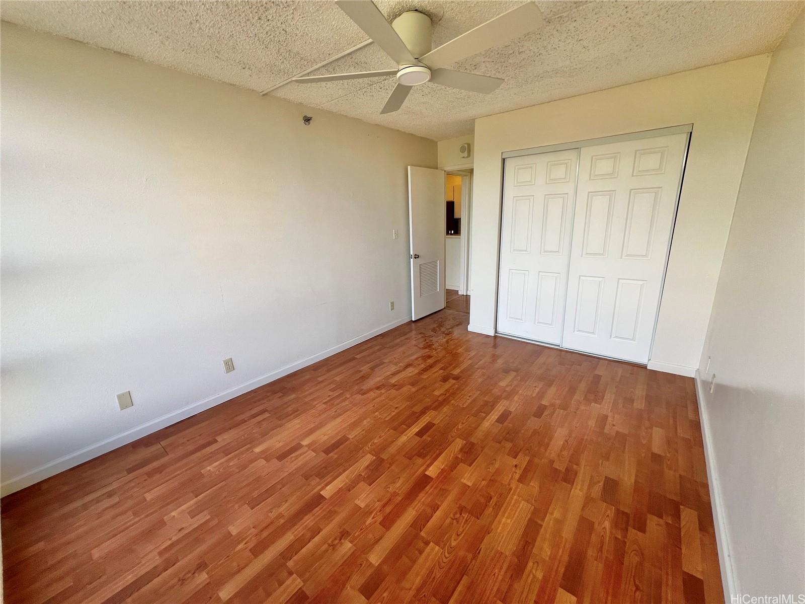 98-402 Koauka Loop, Unit 2113 Aiea, HI 96701 - Photo 7 of 7 wooden floor in an empty room