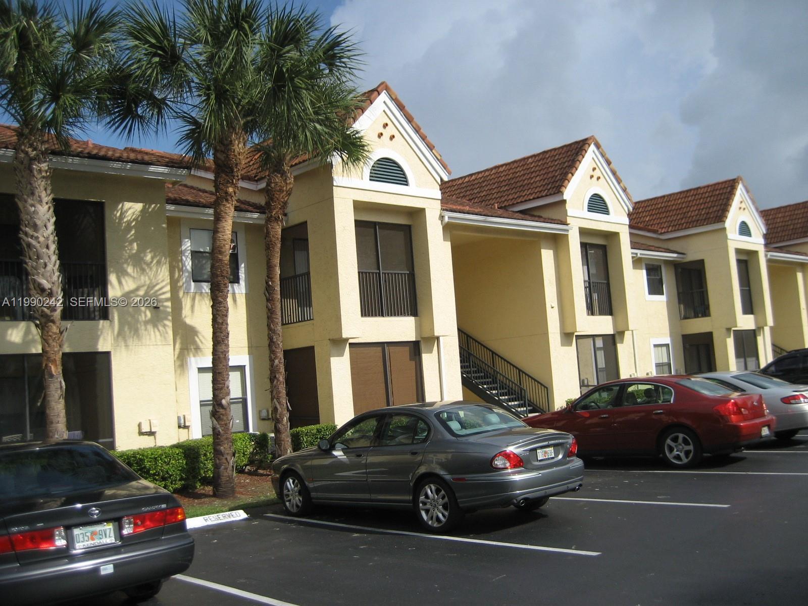 15051 Southwest 103rd Lane, Unit 4103 Miami, FL 33196 - Photo 1 of 19 a view of a car parked in front of a house