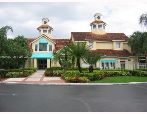 15051 Southwest 103rd Lane, Unit 4103 Miami, FL 33196 - Photo 12 of 19 a front view of a house with a yard