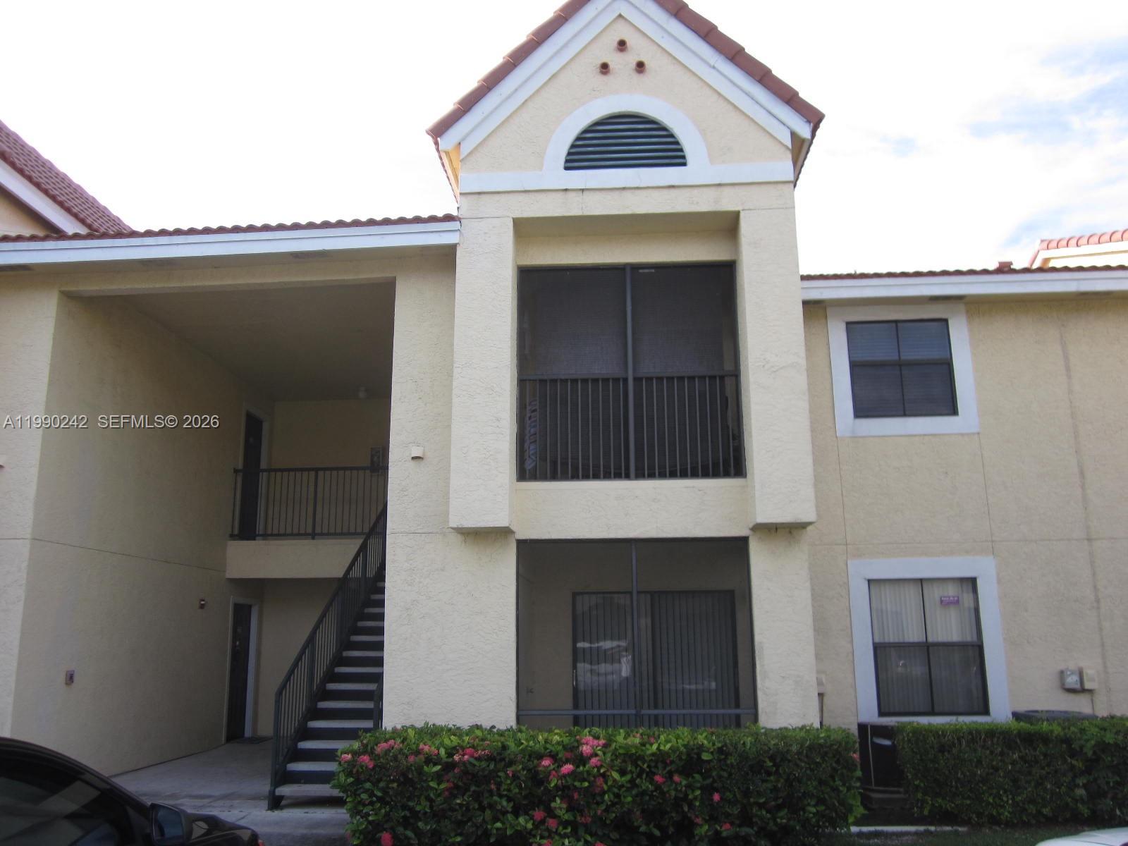 15051 Southwest 103rd Lane, Unit 4103 Miami, FL 33196 - Photo 14 of 19 a front view of a house with a garage